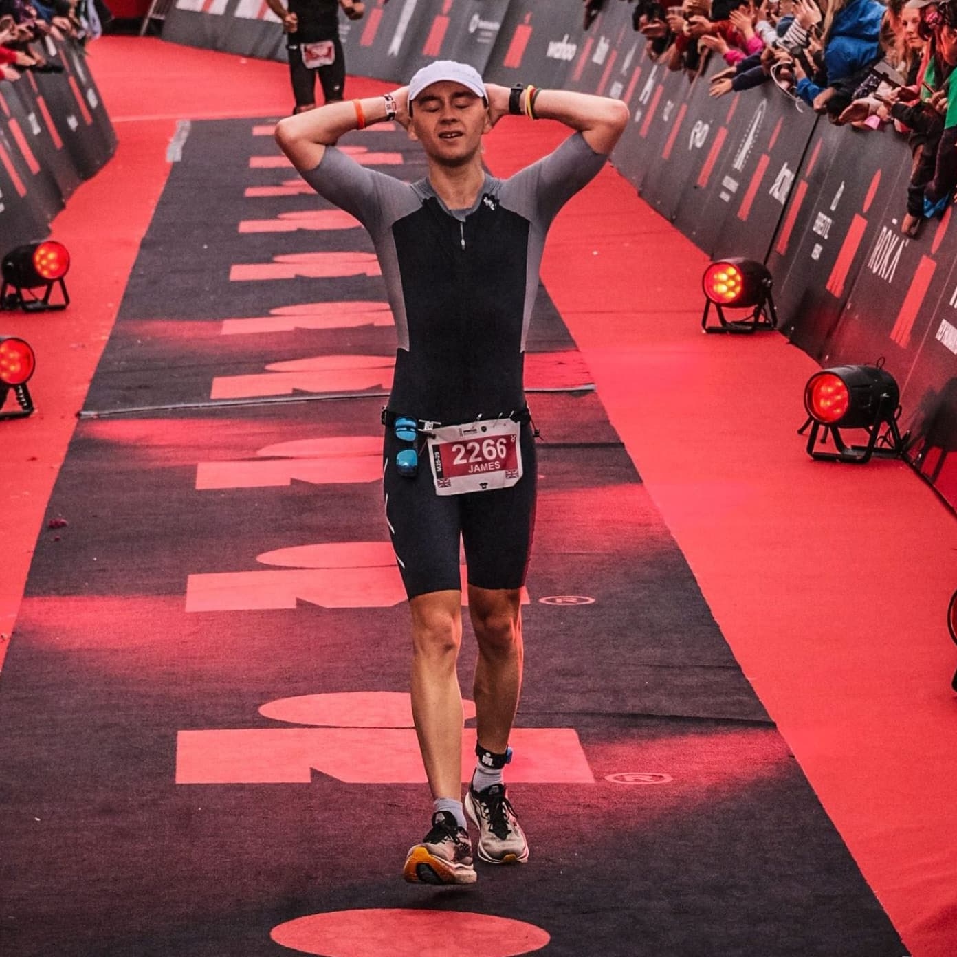 James McAulay crossing the finish line at an ironman event